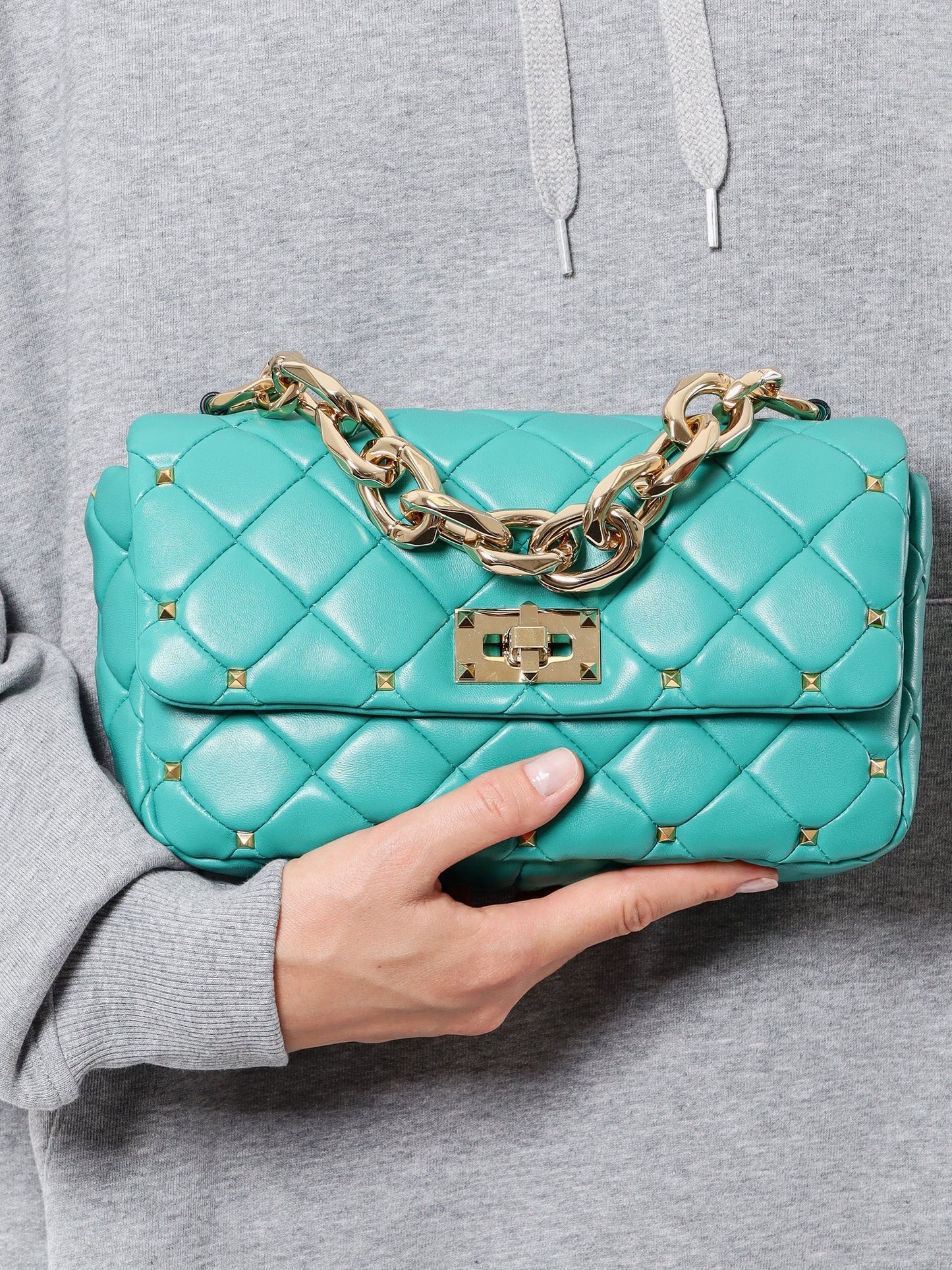 Matelassé leather shoulder bag with iconic studs