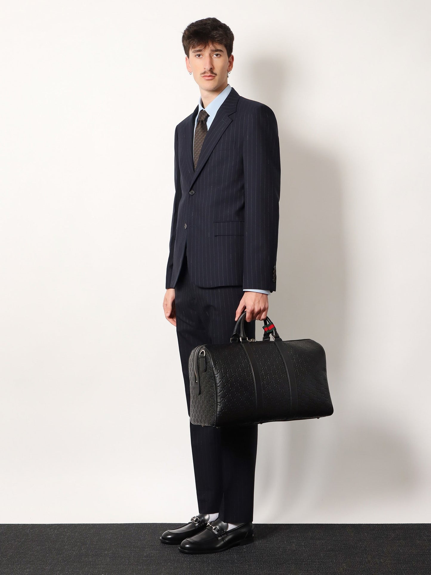 Coated canvas GG Emblem travel bag with GG motif